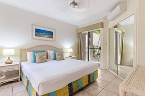 Experience ultimate comfort in the primary king-sized bedroom featuring a large wardrobe and convenient access to the outdoors. Wake up to the gentle breeze and embrace the coastal serenity right from your bedroom.