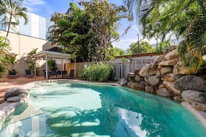 Immerse yourself in the refreshing waters of the pool, surrounded by lush tropical landscapes.