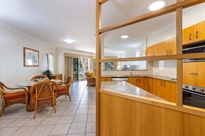 Experience the joy of cooking and dining in this stylish open-plan kitchen and dining area. 