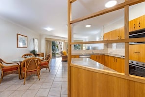 Experience the joy of cooking and dining in this stylish open-plan kitchen and dining area.
