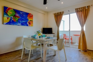 Table, flat screen tv with cable, balcony
