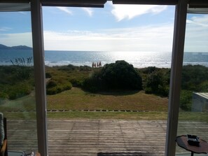 Looking from the living room through the double doors towards the beach