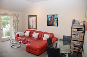 Spacious and comfortable lounge with deck access, wide screen TV and SkyTV