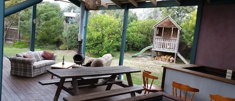 Under covered back deck with bar, TV, BBQ, Chimenea and lounges