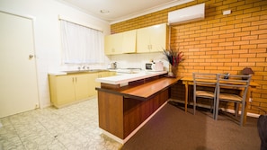 Kitchen with breakfast bar and work area
