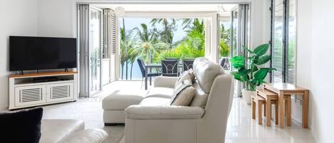 Wall-to-wall bi-fold glass doors open up all the way so you can bask in the sunshine and sea breezes.