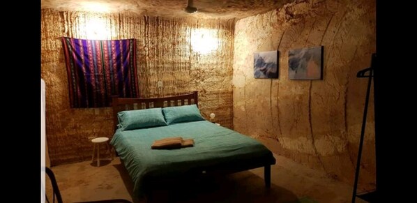 Huge room with seated area and large window and fan - an Adult space!