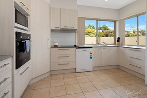 Light, bright kitchen looking out to private courtyard