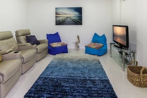 Cosy up in the media room, offering a second TV surrounded by leather recliners and bean bag chairs.