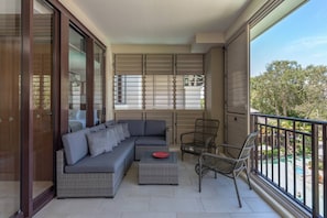 The private balcony is set with a lounge and chairs to enjoy your morning coffee while soaking up the fresh, coastal breezes.