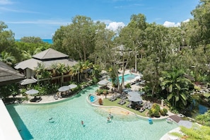 The resort's shared pool is available for guest use, lined with palms and offering ample seating to lay out in the sun.