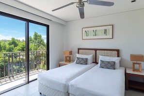 Flexibility abounds in the air-conditioned second bedroom with two singles, which can be pushed together to create a king bed upon request.