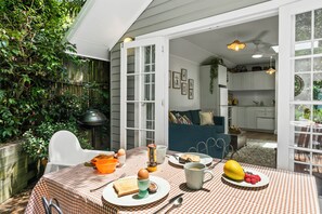 Private courtyard, with table and chairs for 4 guests and electric bbq in summer