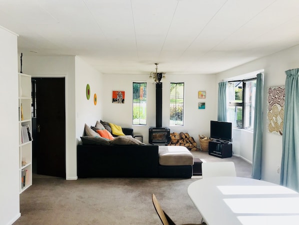 The spacious living room with wood burner