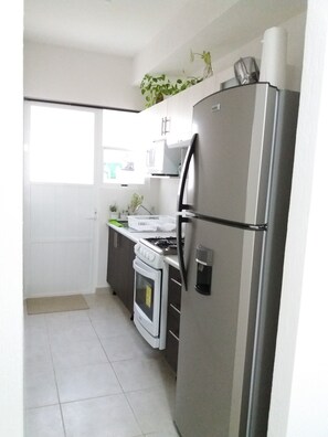 kitchen with utensils, coffee machine, mixer, pans etc