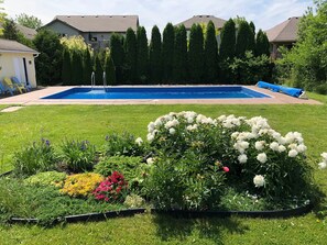 Large pool surrounded by colourful gardens