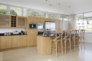 Fully-equipped kitchen including integral coffee machine.