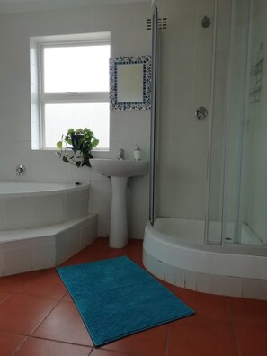 Main bathroom with a shower and a bath. 