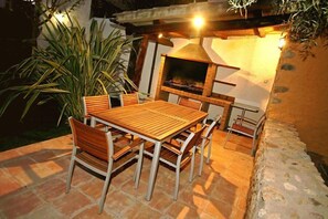 In the garden, there is a large BBQ 
