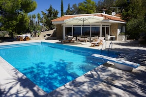The pool house and its beautiful patio
