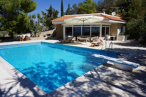 The pool house and its beautiful patio