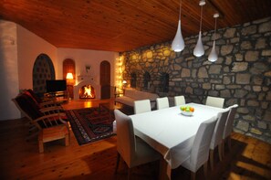 Comfortable sitting and dining room with open fire. 