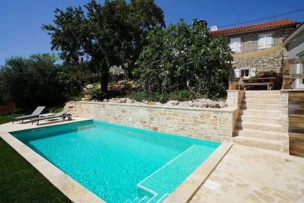 natural stone villa and pool with relaxing area