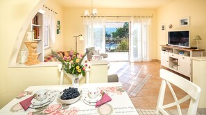 airy living room and dining area with sea view