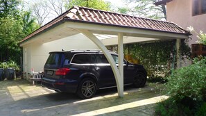 The carport parks two cars. There is one more parking in front of the house.