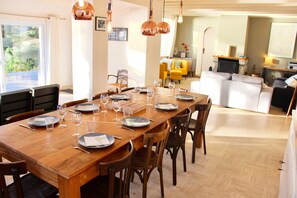 Large open dining and living room with seaview and fireplace