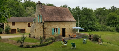 Vue de la maison et de la grange depuis le bois