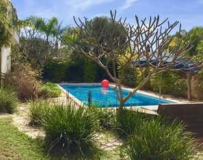 Very private pool area with many flowering bushes. Francipani in pink and white.