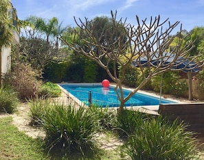 Very private pool area with many flowering bushes. Francipani in pink and white.