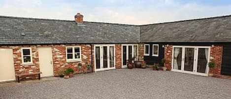 Courtyard showing Txoko Cottage (left) and Little Owls Cottage (right)