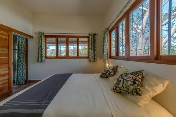 Master bedroom with a beautiful view in the middle of nature