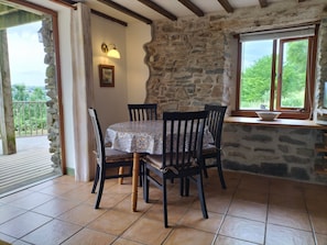 The dining area with the exposed original stone wall.