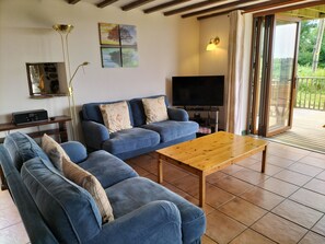 The lounge area with comfy sofas, a smart TV, DVD player and a digital radio.