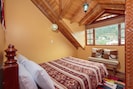 Double bed room with mountain view, wooden ceiling and floor