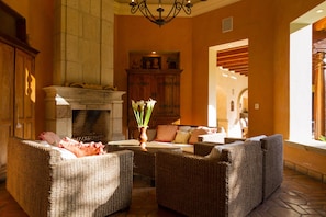 Cozy indoor/outdoor living room with an impressive stone fireplace.