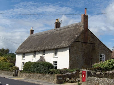 A spacious thatched former farmhouse with indoor pool suitable for large groups