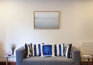 Living Room with air conditioner and new pillows/sofa cover
