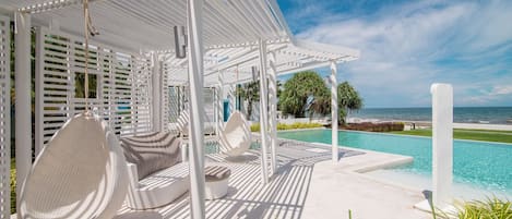 Relax in one of the swing sets by the pool or walk a few steps to the beach