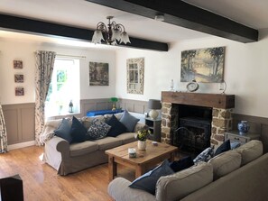Lounge with 3 large sofas and a log burner