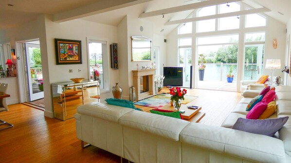 Double height open plan living space opening onto the lakeside terrace.