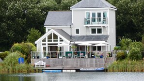 Rear view of the property with assorted water craft
