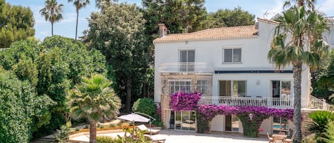 View of the villa, pool and gardens