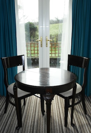 Double doors onto a small patio and the field beyond