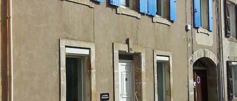 The front of the house with new wooden shutters