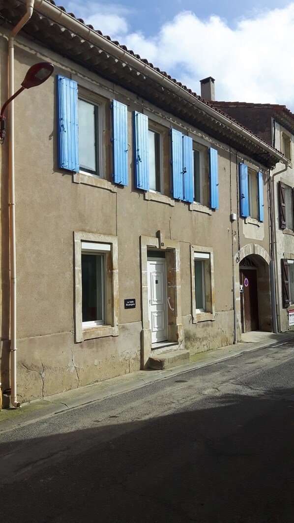 The front of the house with new wooden shutters