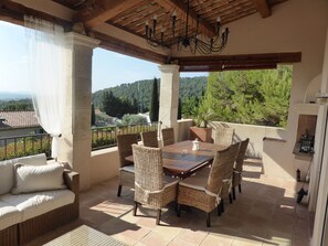 Comfortable sofa, big dining table and fireplace/BBQ on the terrace